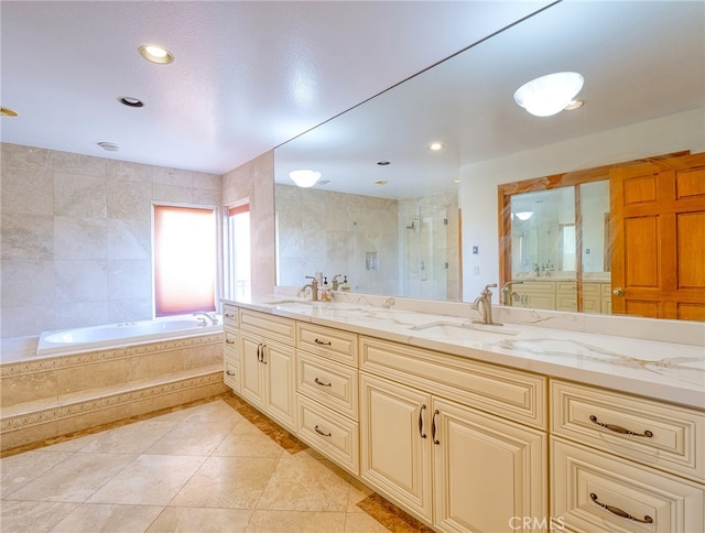 bathroom with plus walk in shower, tile patterned floors, and vanity