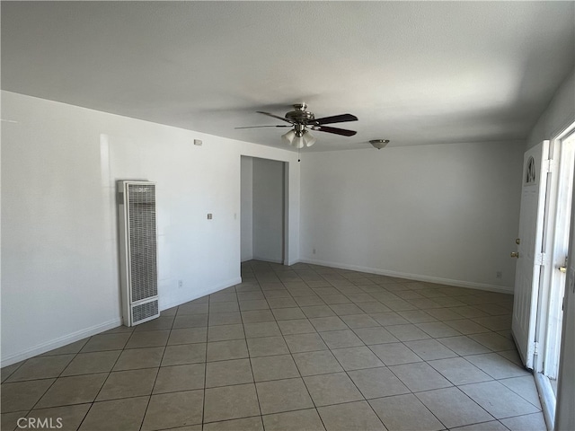 tiled empty room featuring ceiling fan