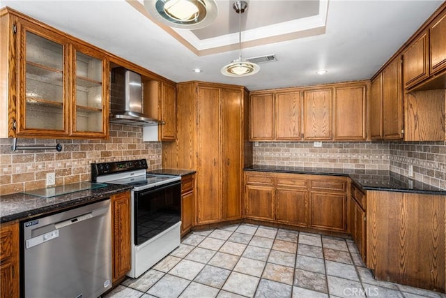 kitchen featuring backsplash, stainless steel dishwasher, range with electric stovetop, and wall chimney range hood