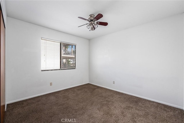 carpeted spare room featuring ceiling fan