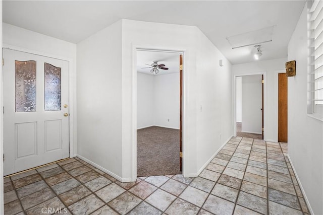 entrance foyer featuring ceiling fan and light carpet