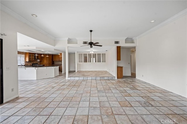 unfurnished living room featuring ceiling fan and crown molding