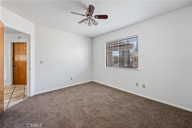 spare room featuring ceiling fan and carpet floors