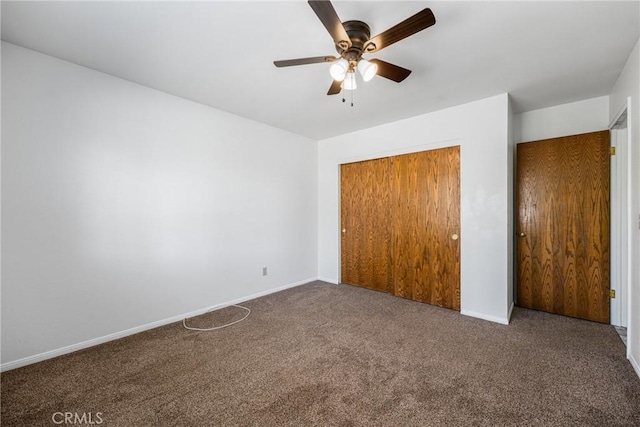 unfurnished bedroom featuring ceiling fan, a closet, and dark colored carpet