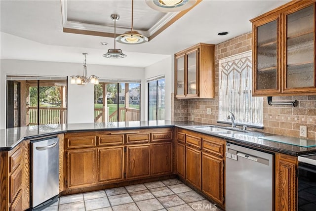 kitchen with dishwasher, a raised ceiling, sink, hanging light fixtures, and tasteful backsplash