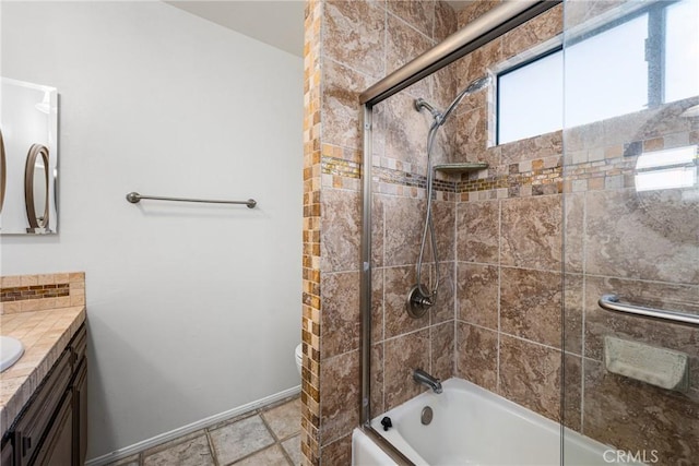 bathroom with vanity and shower / bath combination with glass door