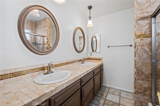 bathroom featuring tasteful backsplash, vanity, and walk in shower