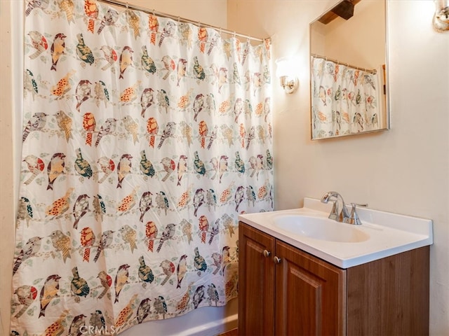 bathroom featuring vanity and shower / bathtub combination with curtain