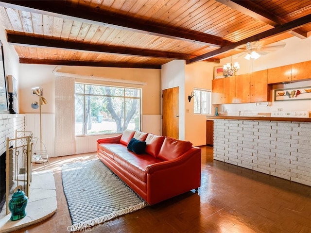 living room with ceiling fan, wood ceiling, dark wood-type flooring, lofted ceiling with beams, and a fireplace