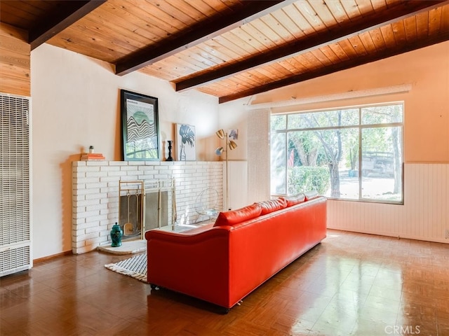 living room with wood walls, a fireplace, lofted ceiling with beams, and wood ceiling