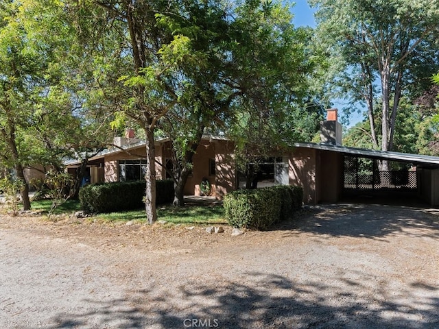 view of front of property featuring a carport