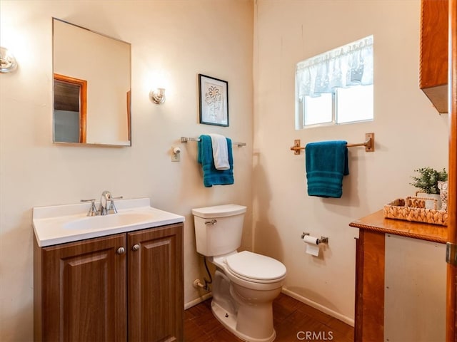 bathroom featuring vanity, toilet, and hardwood / wood-style flooring