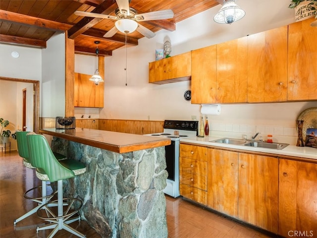 kitchen featuring beamed ceiling, electric stove, hanging light fixtures, ceiling fan, and wooden ceiling