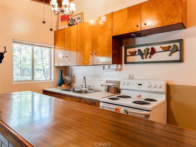 kitchen with tasteful backsplash, white electric range, sink, and a notable chandelier