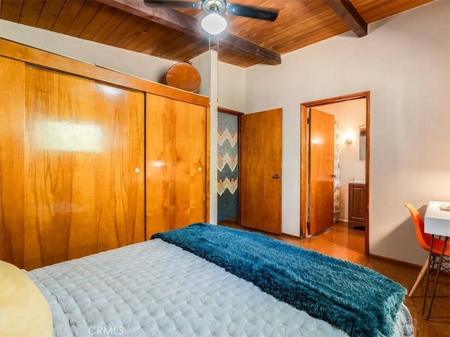 bedroom featuring a closet, ceiling fan, beamed ceiling, and wooden ceiling