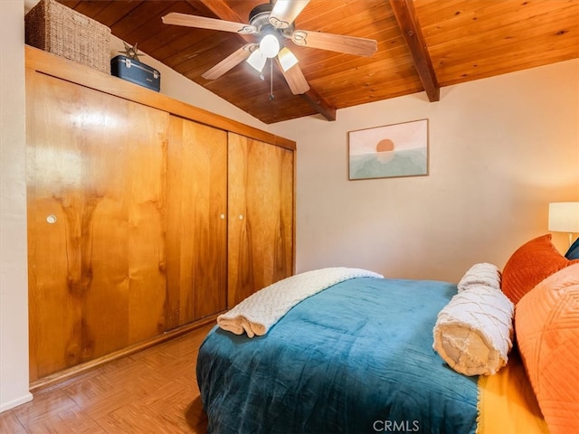 bedroom featuring wood ceiling, lofted ceiling with beams, a closet, and light parquet floors