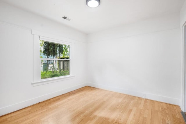 spare room featuring hardwood / wood-style floors