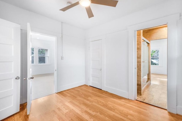 unfurnished bedroom with ceiling fan and light hardwood / wood-style flooring