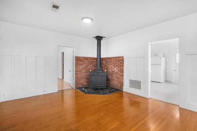 unfurnished living room featuring hardwood / wood-style flooring