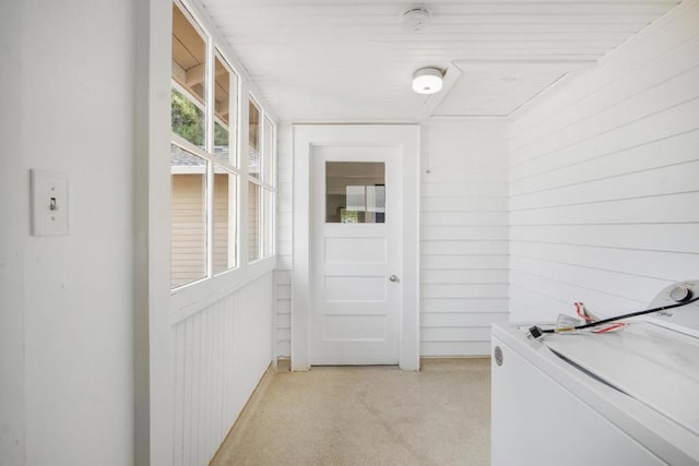 laundry room with wood walls