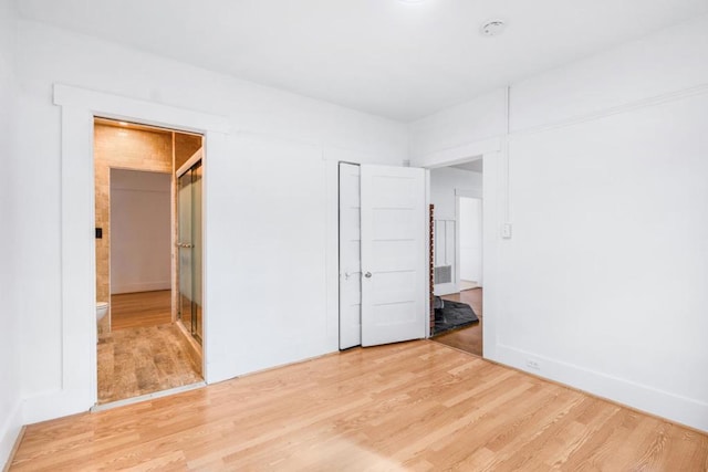 unfurnished bedroom with a closet and hardwood / wood-style flooring