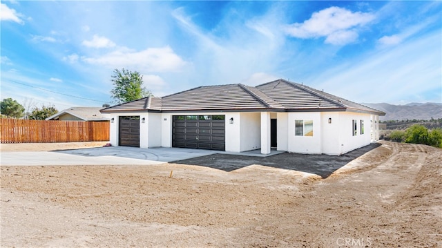 view of front of home featuring a mountain view and a garage