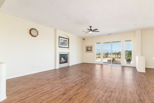 unfurnished living room with ceiling fan and hardwood / wood-style flooring