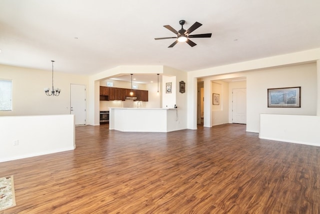 unfurnished living room featuring ceiling fan with notable chandelier, dark hardwood / wood-style floors, and sink