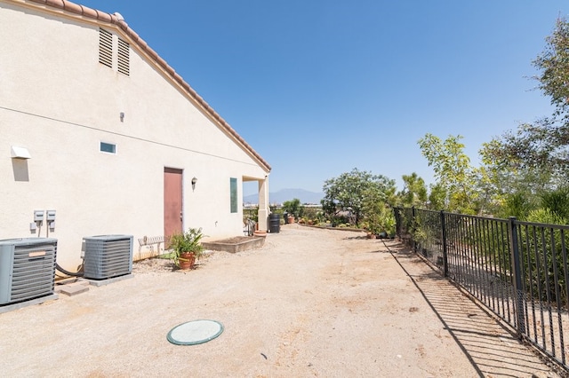 view of side of property featuring central air condition unit