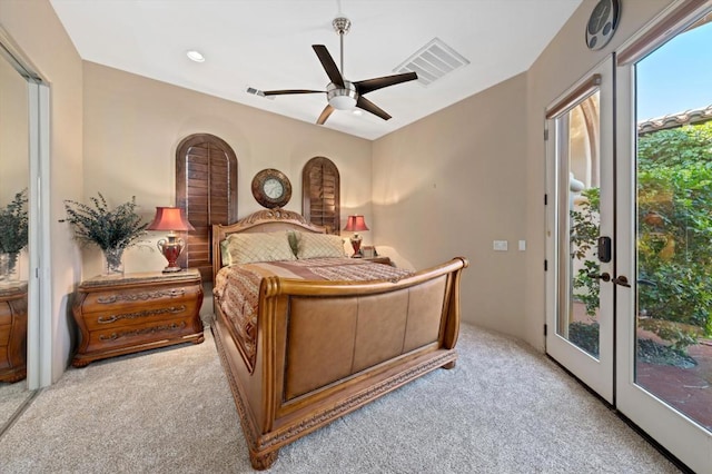 bedroom with access to exterior, french doors, light colored carpet, and ceiling fan