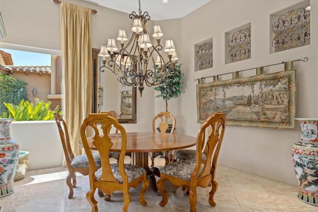 tiled dining area featuring a notable chandelier