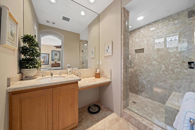 bathroom with vanity, tile patterned floors, ceiling fan, and a shower with shower door