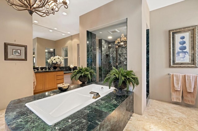 bathroom with tile patterned flooring, vanity, separate shower and tub, and a chandelier