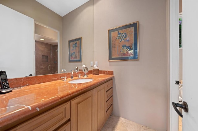 bathroom with tile patterned flooring, vanity, and walk in shower