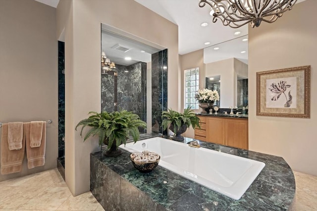 bathroom with plus walk in shower, vanity, and an inviting chandelier