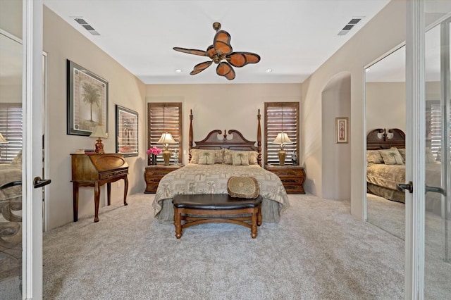 carpeted bedroom with ceiling fan and french doors