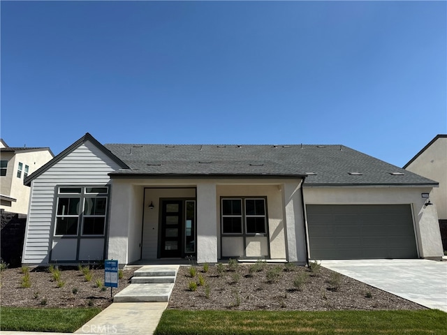 15949 Conservatory Dr, Fontana, CA 92336 - view of front of home featuring a garage, concrete driveway, and stucco siding