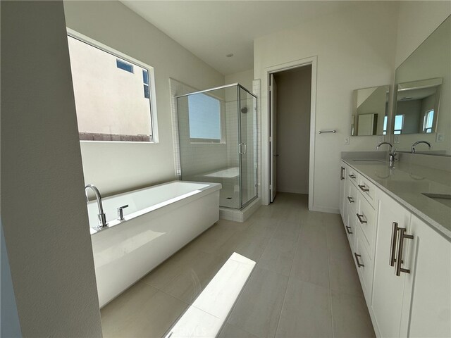 15949 Conservatory Dr, Fontana, CA 92336 - full bath featuring a soaking tub, double vanity, a stall shower, and tile patterned flooring