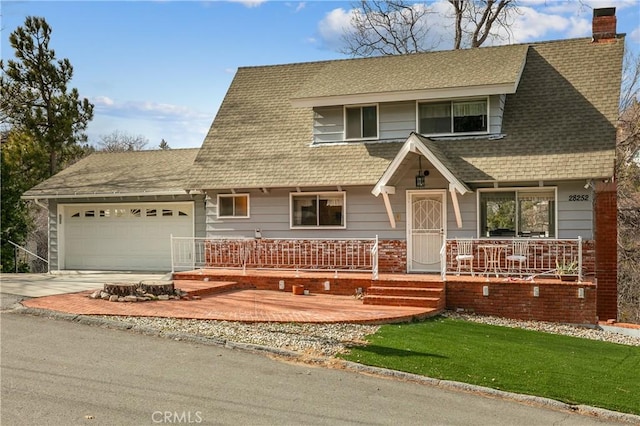 view of front of home with covered porch and a garage