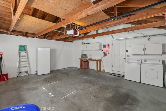 garage featuring separate washer and dryer and a garage door opener