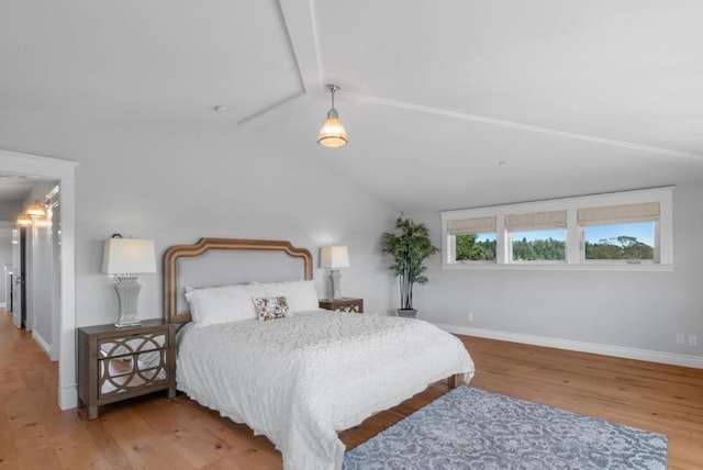 bedroom with hardwood / wood-style floors and lofted ceiling with beams