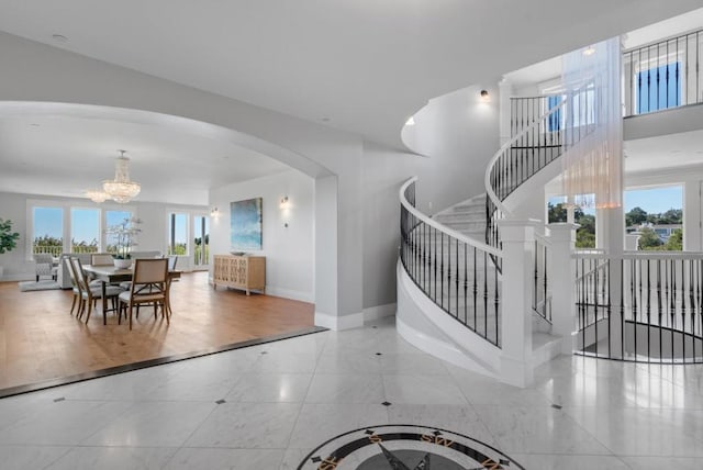 staircase featuring hardwood / wood-style floors and a chandelier