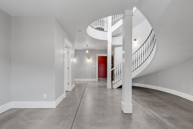 foyer with concrete floors and ornate columns