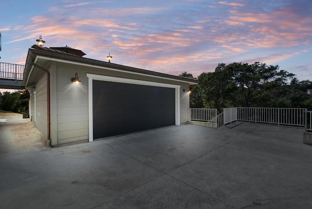 view of garage at dusk