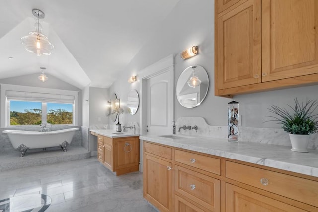 bathroom featuring vanity, a tub, and vaulted ceiling