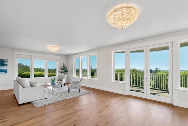 sunroom featuring an inviting chandelier