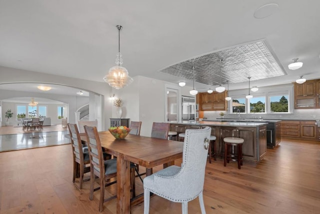 dining room featuring sink and light wood-type flooring