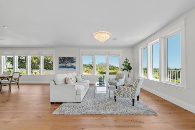 living room with a chandelier and light wood-type flooring