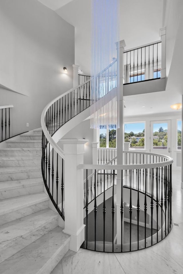 staircase with a towering ceiling