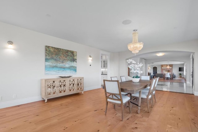 dining space with a chandelier and light hardwood / wood-style floors